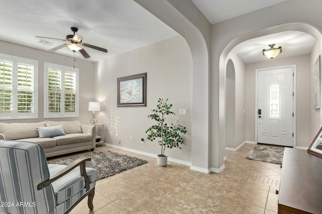 entryway with ceiling fan and light tile patterned flooring