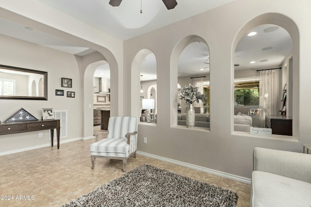 living area featuring ceiling fan