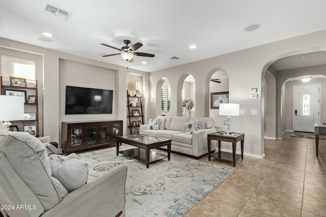 tiled living room featuring ceiling fan