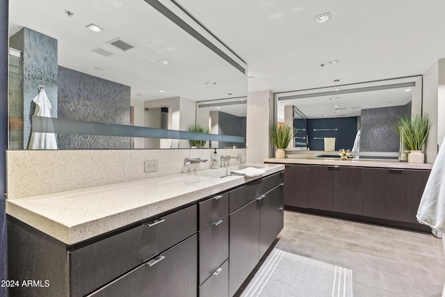 bathroom featuring vanity and tasteful backsplash