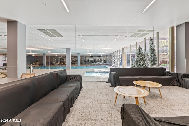 carpeted living room with floor to ceiling windows