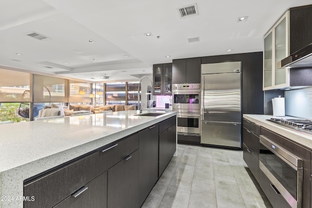 kitchen with sink, wall chimney exhaust hood, and appliances with stainless steel finishes