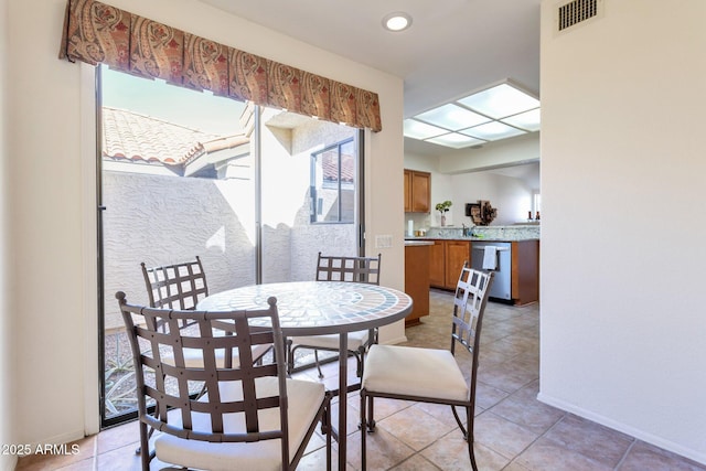 dining room featuring sink and light tile patterned flooring