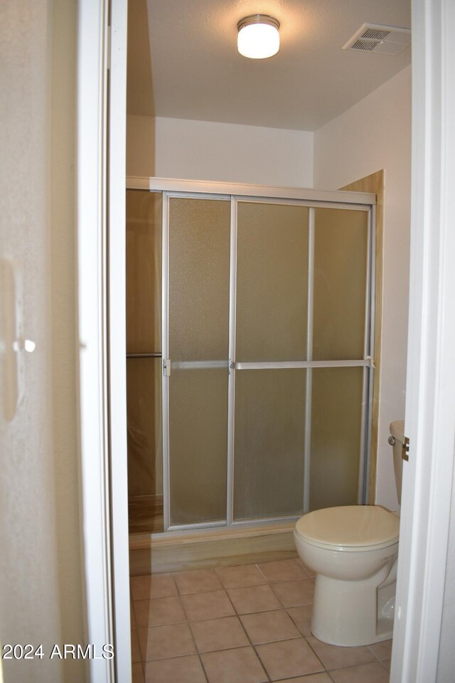 4901 E Magic Stone Dr, Phoenix, AZ 85044 - full bathroom with tile patterned flooring, a shower stall, and toilet
