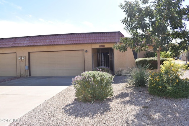 4901 E Magic Stone Dr, Phoenix, AZ 85044 - view of front of property with stucco siding, concrete driveway, a garage, and a tiled roof