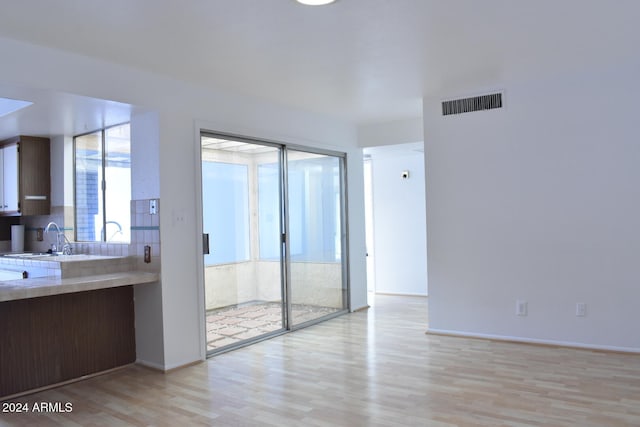 interior space with light wood-type flooring and sink