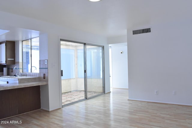 4901 E Magic Stone Dr, Phoenix, AZ 85044 - unfurnished room featuring a sink, light wood-style flooring, and baseboards