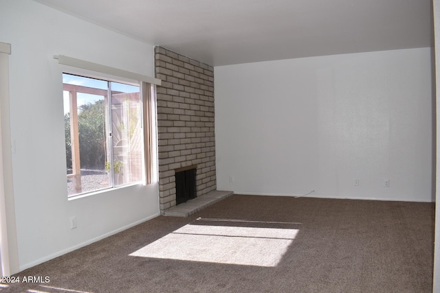 unfurnished living room with a healthy amount of sunlight, carpet floors, and a fireplace