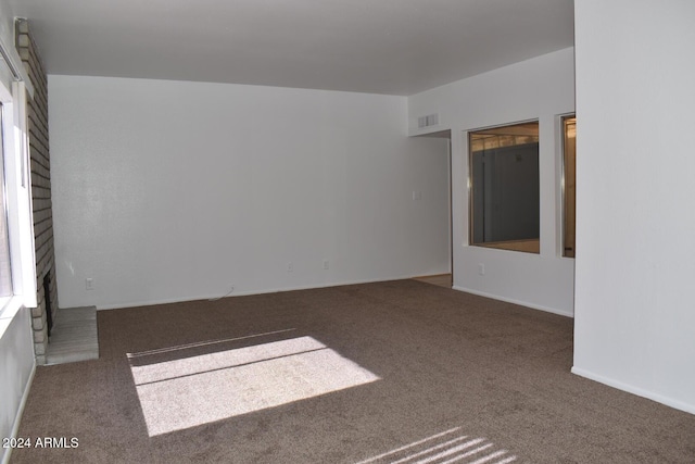 4901 E Magic Stone Dr, Phoenix, AZ 85044 - empty room with carpet flooring and a brick fireplace