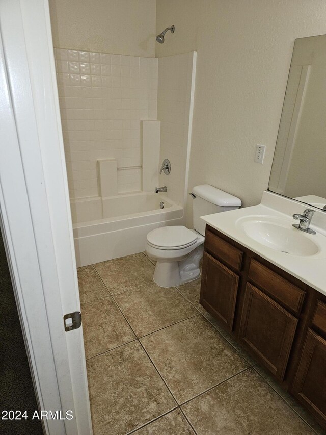 full bathroom featuring toilet, vanity, tile patterned floors, and shower / bathtub combination