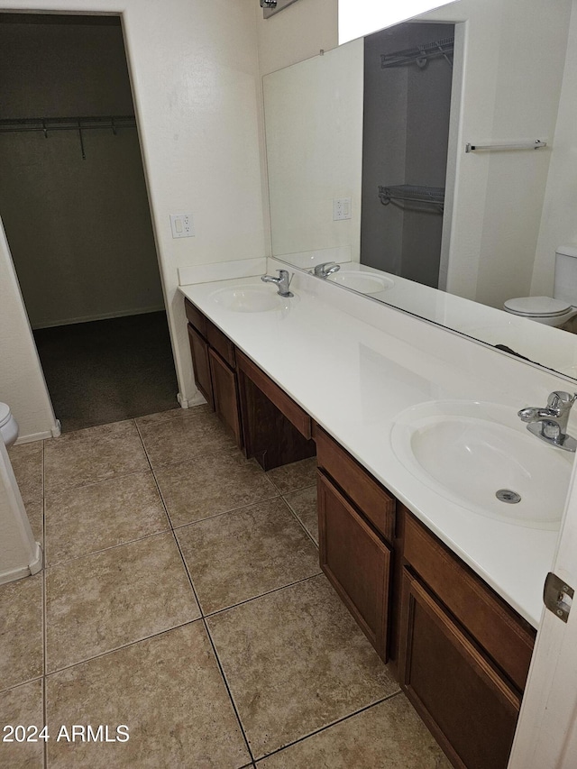 bathroom featuring tile patterned flooring, vanity, and toilet