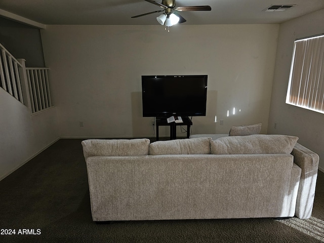 carpeted living room with ceiling fan