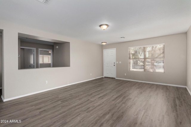 unfurnished room featuring dark wood finished floors and baseboards