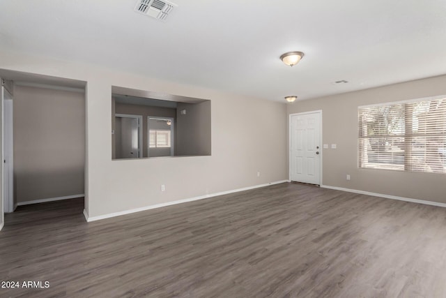 spare room featuring dark hardwood / wood-style floors and plenty of natural light