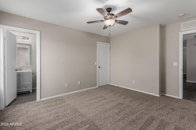 unfurnished bedroom with carpet, ensuite bathroom, ceiling fan, and sink