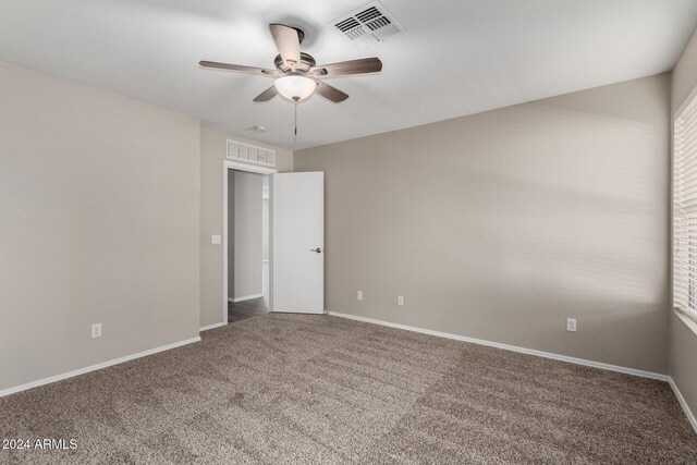 empty room featuring carpet flooring and ceiling fan