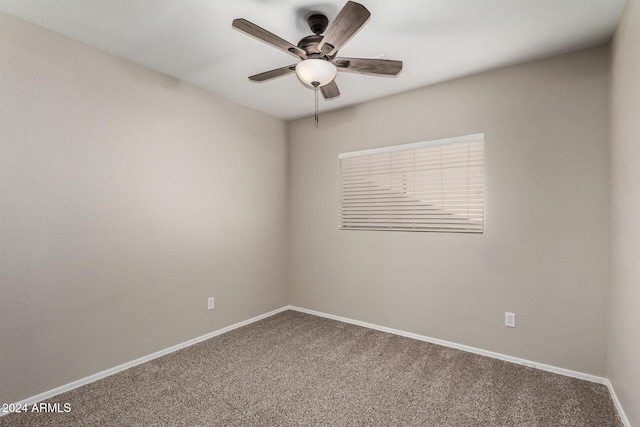 unfurnished room featuring carpet floors, baseboards, and a ceiling fan