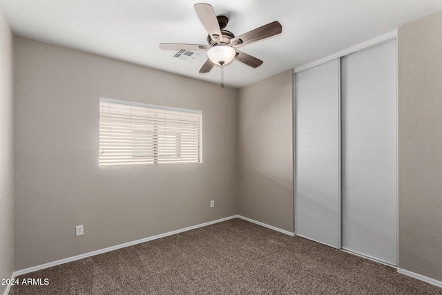 unfurnished room with a ceiling fan, carpet, visible vents, and baseboards