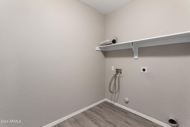 clothes washing area with gas dryer hookup, laundry area, washer hookup, wood finished floors, and baseboards