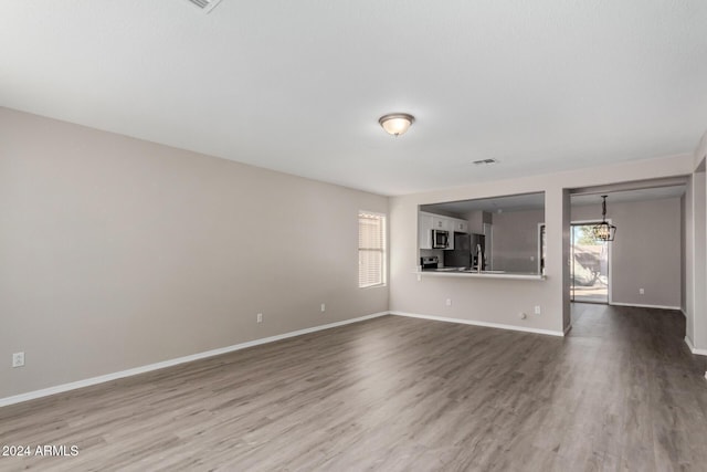 unfurnished living room featuring wood-type flooring