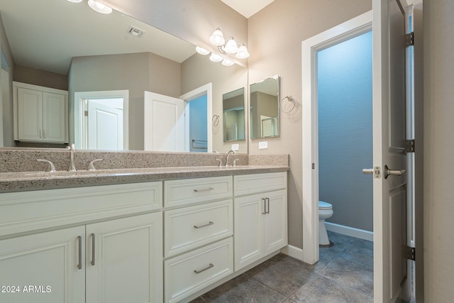 bathroom featuring tile patterned floors, vanity, and toilet