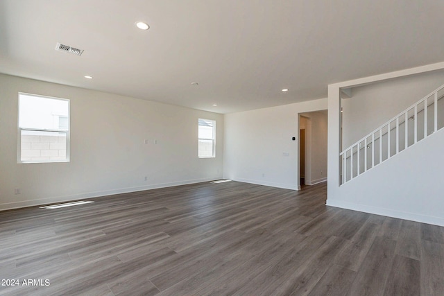 empty room with dark hardwood / wood-style flooring