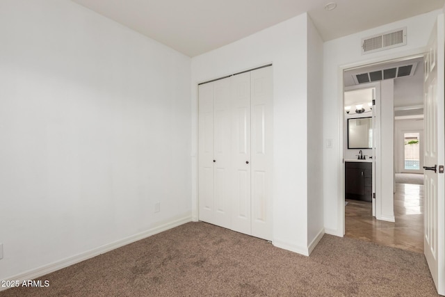 2210 W Tonto Ln, Phoenix, AZ 85027 - unfurnished bedroom featuring carpet flooring, a closet, baseboards, and a sink