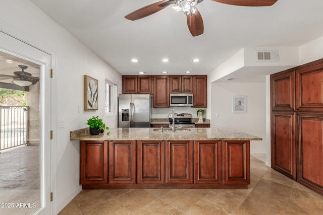 2210 W Tonto Ln, Phoenix, AZ 85027 - kitchen with stainless steel appliances, ceiling fan, a peninsula, a sink, and recessed lighting