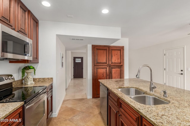 2210 W Tonto Ln, Phoenix, AZ 85027 - kitchen with appliances with stainless steel finishes, a sink, light stone countertops, recessed lighting, and baseboards