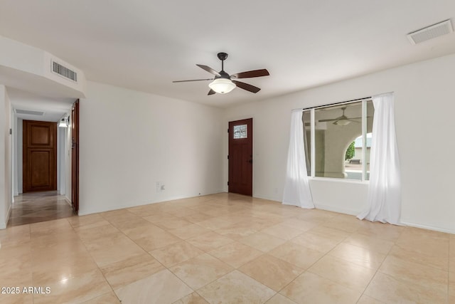 2210 W Tonto Ln, Phoenix, AZ 85027 - empty room featuring a ceiling fan, healthy amount of natural light, and light tile patterned flooring
