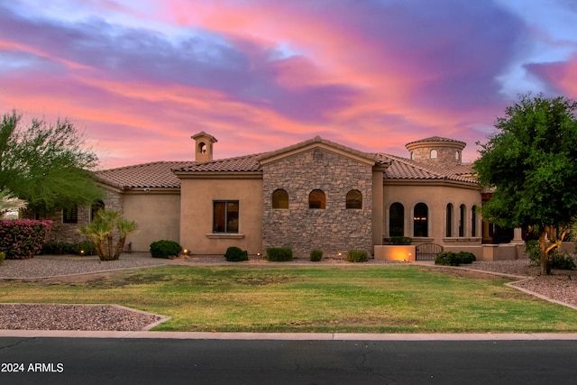 mediterranean / spanish house with a yard