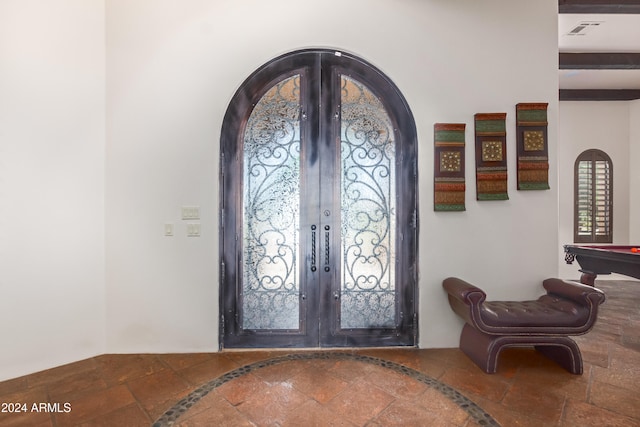 entrance foyer with beamed ceiling, french doors, and pool table