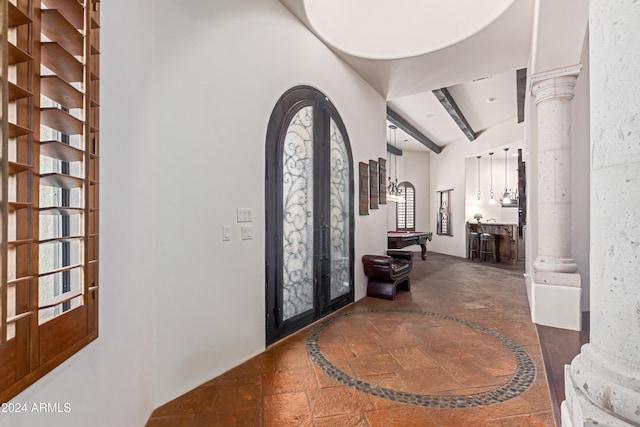 entryway featuring french doors, ornate columns, pool table, beamed ceiling, and a healthy amount of sunlight