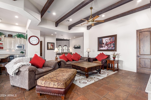 living room featuring ceiling fan, beam ceiling, and beverage cooler