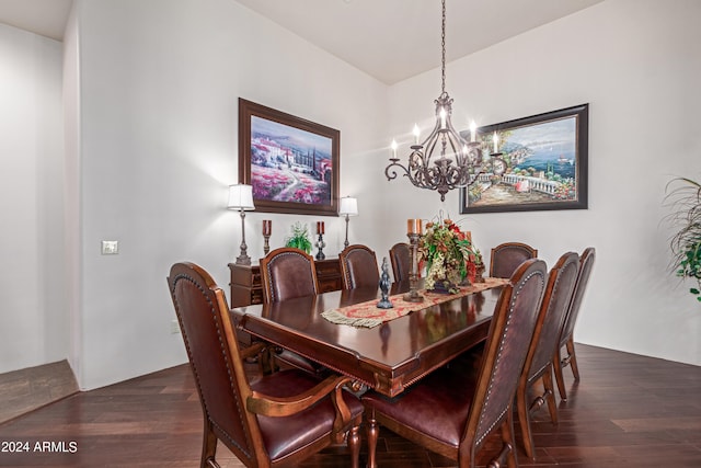 dining area featuring dark hardwood / wood-style floors and an inviting chandelier