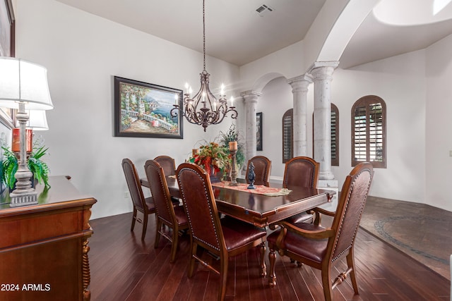 dining room featuring vaulted ceiling, ornate columns, dark hardwood / wood-style floors, and a notable chandelier