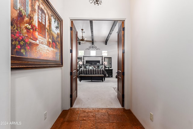 corridor with beam ceiling and carpet