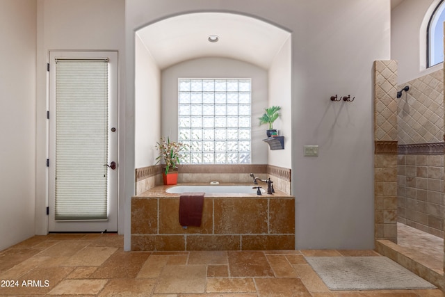 bathroom featuring independent shower and bath