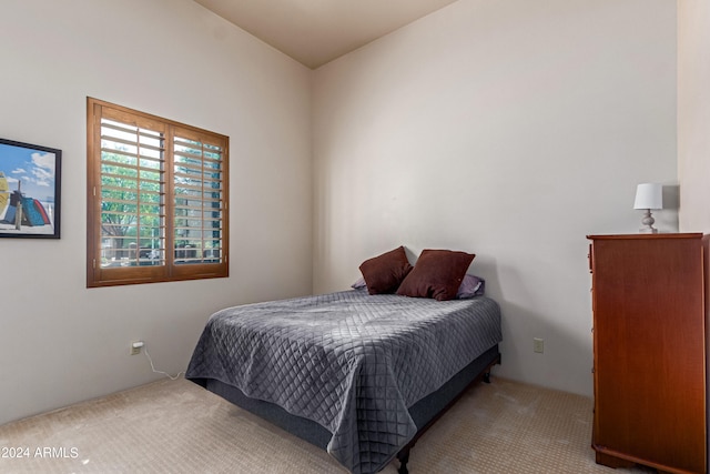 bedroom featuring light carpet