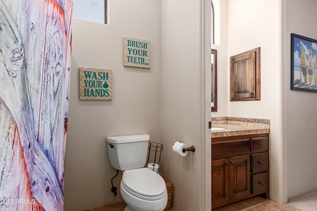 bathroom with tile patterned floors, vanity, and toilet