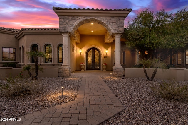 view of exterior entry at dusk