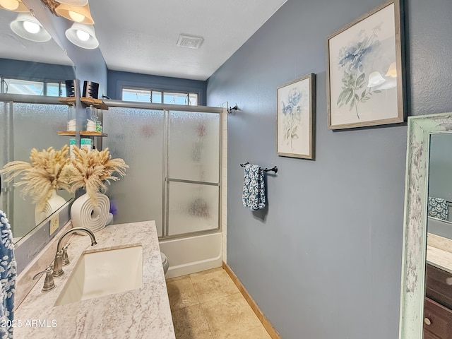 4639 W Keim Dr, Glendale, AZ 85301 - bathroom featuring vanity, combined bath / shower with glass door, baseboards, and toilet