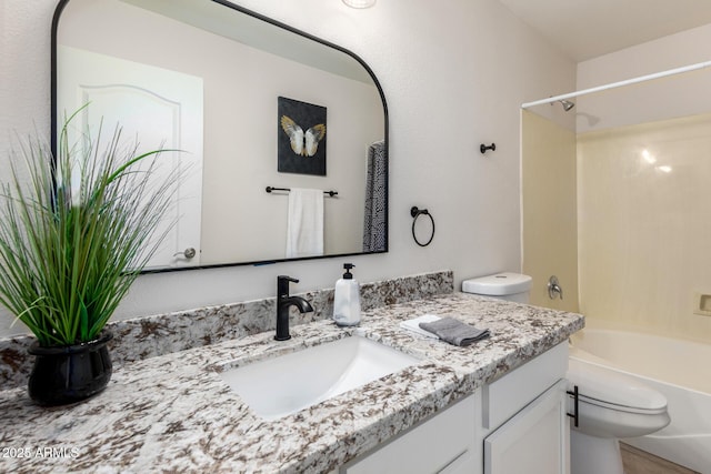 bathroom featuring vanity, toilet, and washtub / shower combination