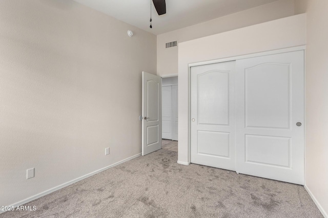 unfurnished bedroom with visible vents, a ceiling fan, a closet, carpet floors, and baseboards