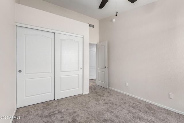 unfurnished bedroom with a closet, carpet flooring, baseboards, and visible vents