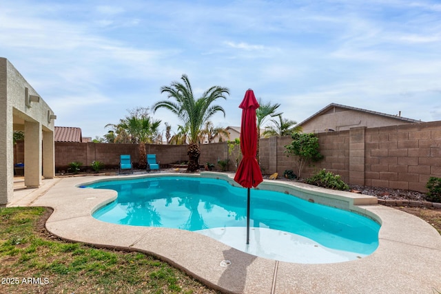 view of swimming pool with a patio area, a fenced in pool, and a fenced backyard