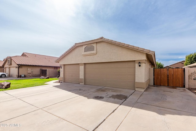 view of front facade featuring a gate, fence, stucco siding, an outdoor structure, and a front lawn