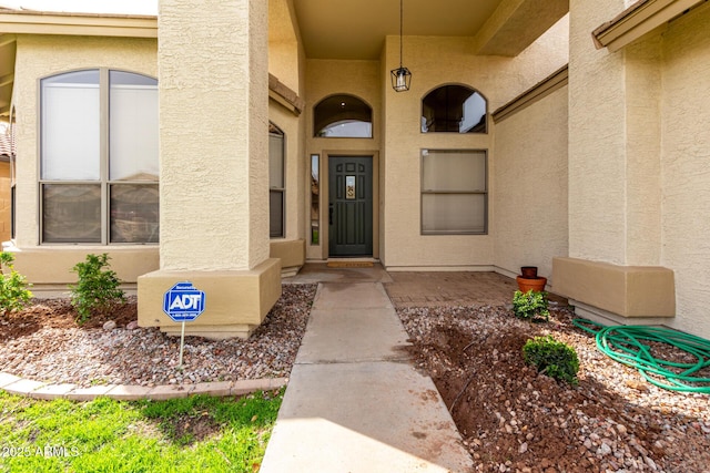 property entrance with stucco siding