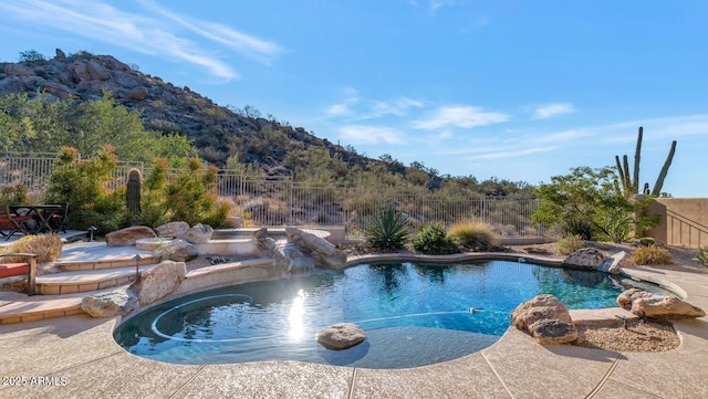 view of pool with pool water feature, a patio area, and a mountain view