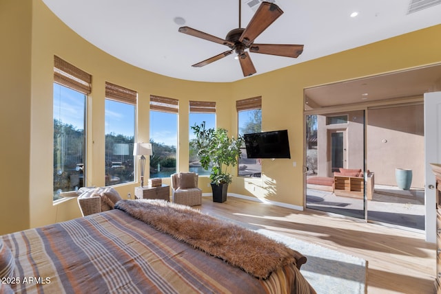 bedroom featuring access to exterior and light hardwood / wood-style floors